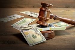 gavel slamming on a stack of money to decide on alimony in new york